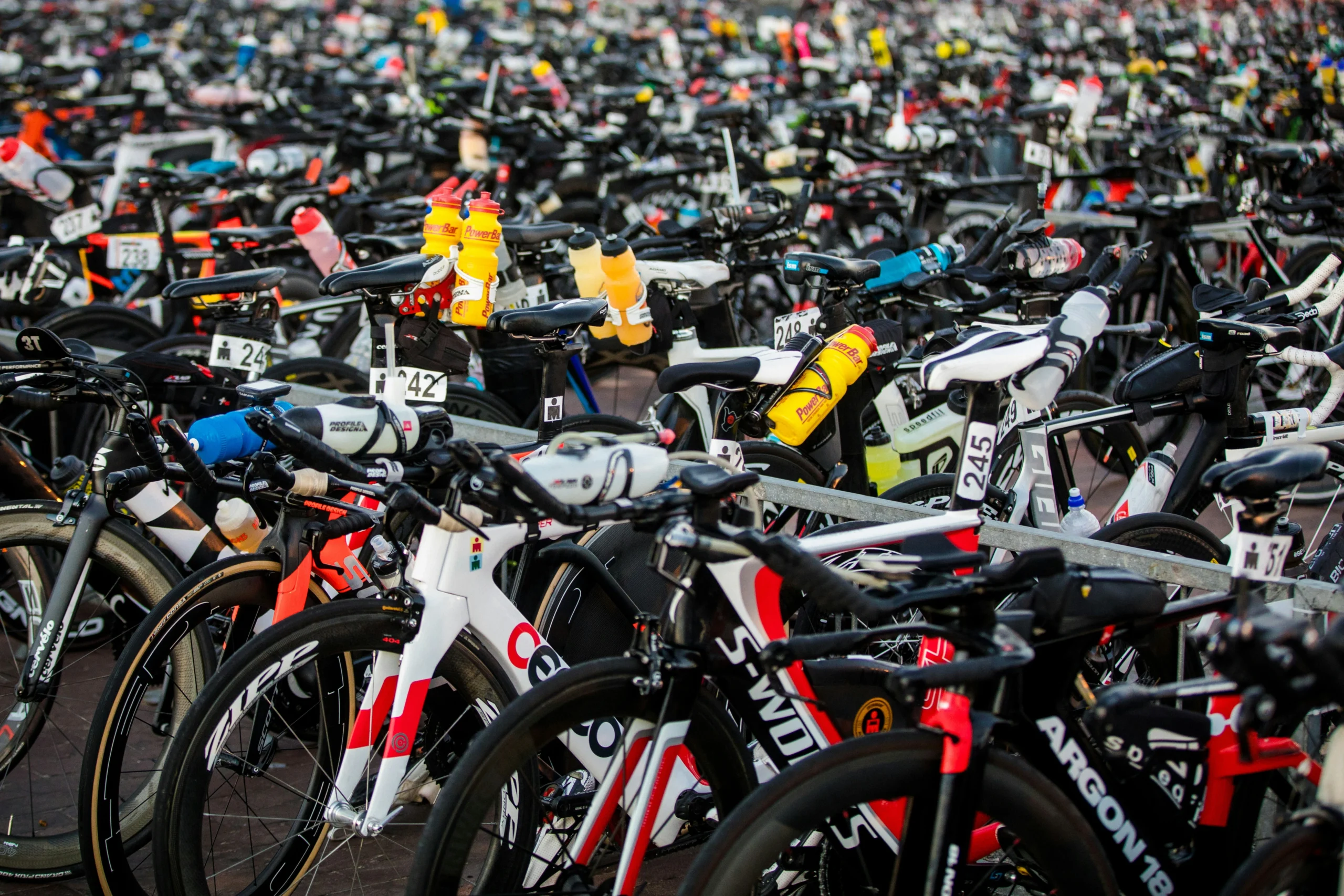 Bikes lined up in a triathlon transition area